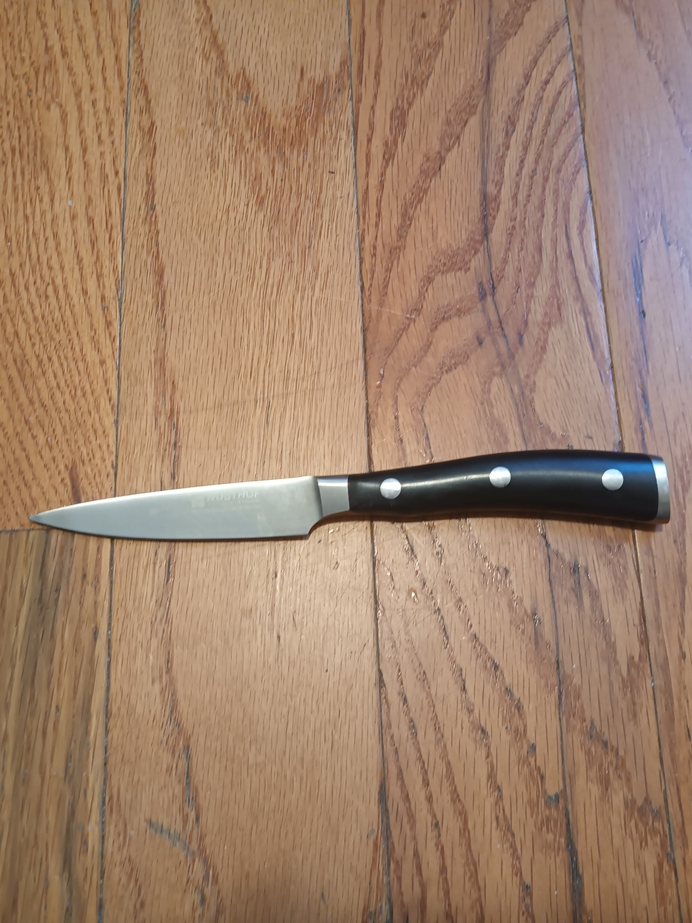 Stainless Steel Paring Knife with Black Handle by Wusthof Classic Ikon.
